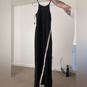 Formal women’s black dress with rhinestone run and slit in front.